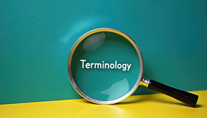 Magnifying glass focusing on terminology word on yellow background. Terminology concept with magnifier on colorful backdrop. Education and learning with magnifying glass.