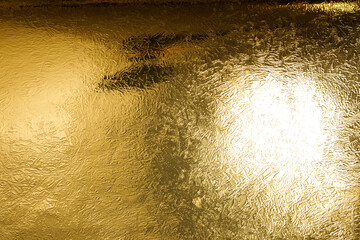 Luxurious gold background with a textured, shimmering surface, ideal for design templates and presentations. U © vegefox.com