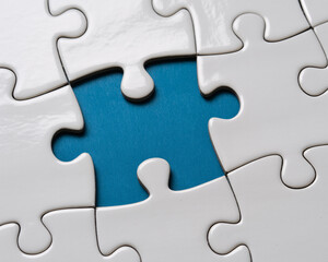 Fototapeta premium Jigsaw puzzle pieces with one blue piece, problem solving and teamwork concept