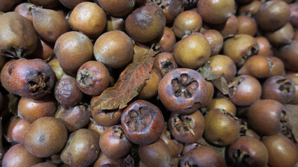 Ripe medlar fruits displayed for sale at market.