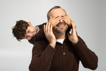 Joyful moments shared between a father and his playful little son in a warm embrace