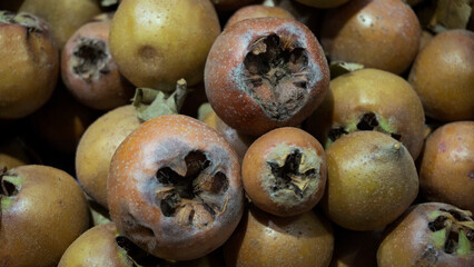 Ripe medlar fruits displayed for sale at market. close-up