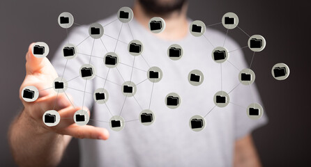 Hand reaching out to connected network of folders representing global data storage. Digital files and network d