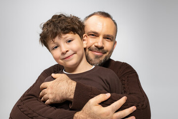 Joyful moments shared between a father and his young son in a warm embrace