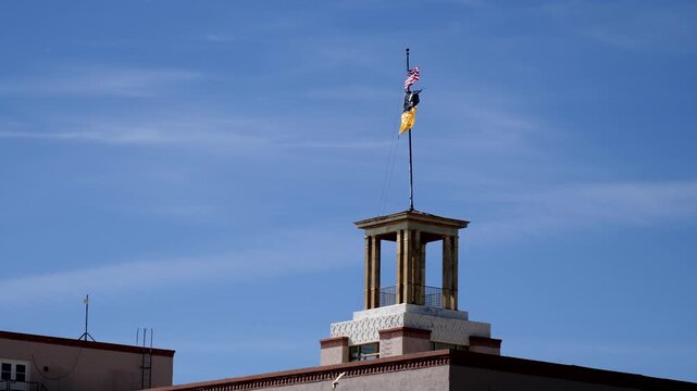 American, New Mexican, and POW flags fly atop the Bataan Monument in Santa Fe. as seen from the state capitol building