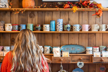 rustic store exhibits vibrant ceramics, autumnthemed boutique showcases warm lighting