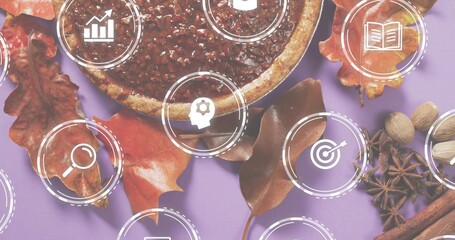 Displaying round tart with nut topping among autumn leaves, spices on lavender backdrop, UI icons © vectorfusionart