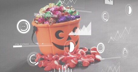Showing orange jack-o'-lantern bucket with black handle holding foil candies on gray tabletop, HUD © vectorfusionart