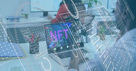 Displaying silver laptop showing NFT on office desk, showing AR overlays, team wearing smart shirts