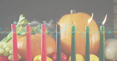 Showing row of seven tapers burning on wooden table at home, with smoke, waveform, pumpkins
