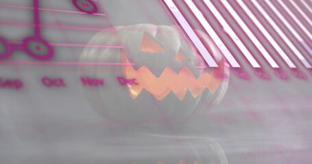Fototapeta premium Emitting warm light, carved jack o lantern glowing on glossy surface in studio, with pink charts
