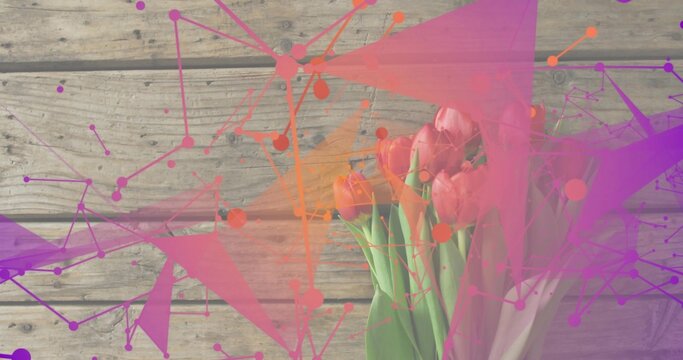 Showing pink tulip bouquet, green stems in pale wrap on wooden plank, colorful overlays, copy space