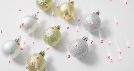 Metallic gold silver baubles resting on white table, showing 0s and 1s falling in red-white streams