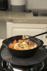 Fresh lamb stew with carrots cooking in pot - delicious homemade meal preparation