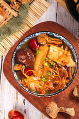 Traditional Asian Mushroom Soup with Bamboo Shoots and Colorful Vegetables in Decorative Bowl