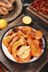 Spicy Cooked Prawns Seafood Dish with Lemon and Chili Peppers on Wooden Table