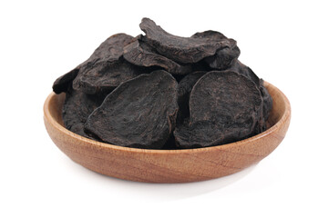 Dried Black Shouwu Chinese Herbal Medicine Slices in Wooden Bowl Traditional TCM Preparation