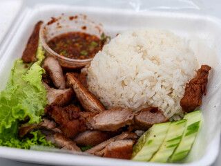 Grilled pork neck with rice and spicy Thai dipping sauce presented in a flavorful, appetizing style