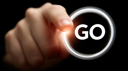 A hand pressing a glowing button that says "GO" against a black backdrop