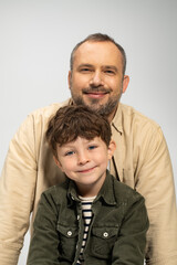 Father and son share a joyful moment in a warm, loving embrace during family time