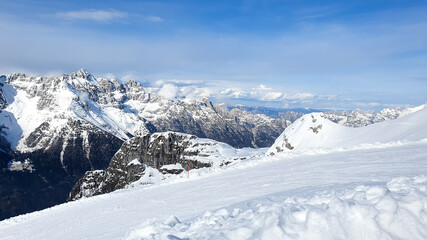 High-altitude slopes stretch across a dramatic backdrop of the rugged, snow-covered Alps, offering an ideal setting for alpine skiing with wide open terrain and smooth downhill lines.