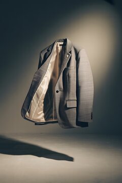 Luxury faux fur tiger print bomber jacket floating in dramatic studio lighting