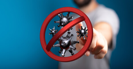 Hand displaying a prohibition sign over virus particles, symbolizing stopping the spread of disease, concept o