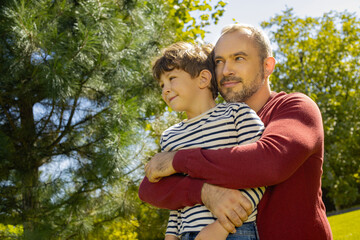 Cherishing moments between father and son at a sunlit park
