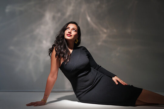 attractive fashionable natural woman posing in white trendy dress, on glittering glamour background