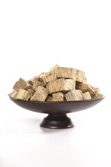 Traditional Medicinal Herbs and Roots in Bowl for Natural Health Treatment