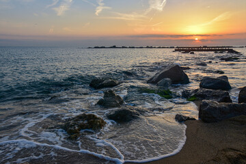 Waves crashing on rocky shore beach.
