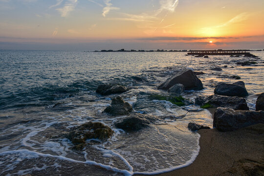 Waves crashing on rocky shore beach. - Powered by Adobe