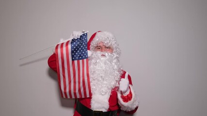 Patriotic santa claus waving an american flag - Powered by Adobe