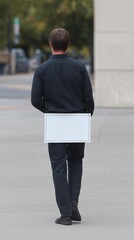 Man Sign determined individual walks along city street, holding sign, symbolizing resilience opportunity. man walking street