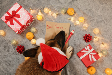 A German Shepherd in a Santa hat lies near a Dear Santa letter with presents, bows, and glowing...