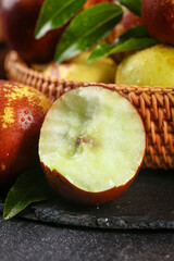 Fresh Cut Apple with Green Leaves in Wicker Basket