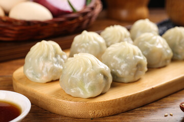 Traditional Chinese Steamed Dumplings on Bamboo Board with Soy Sauce - Asian Dim Sum Breakfast Treats