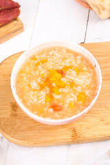 Sweet Potato Vegetable Porridge Bowl on Wooden Board - Healthy Vegetarian Comfort Food