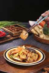 Asian Stir Fry with Tofu Puff Shiitake Mushrooms Carrots and Vegetables in Sauce