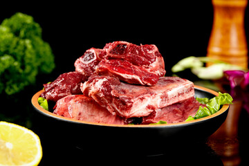 Fresh Raw Beef Steaks and Quality Meat Cuts on Black Background