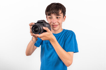young photographer casual dressed Generation Z white male model fun teenage boy photo with DSLR camera. happy smile expressing joy in positive entertaining way in plain background studio setting