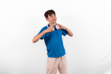 young casual dressed fun happy Gen Z influencer white male model teenage boy with wireless headphones for listening to music podcast or social media from digital device plain background studio setting