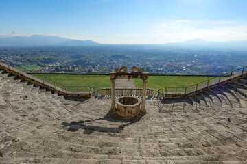 A well in the center of a staircase overlooking the landscape of the province of Rome,in Palestrina, Italy
