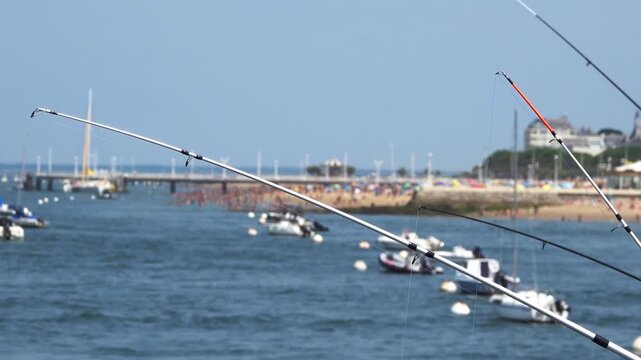 fishing rods on the background of the city beach. Arcachon, France