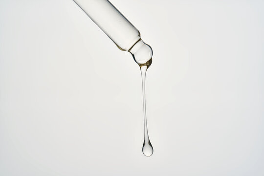 Cosmetic pipette dispensing transparent serum drop