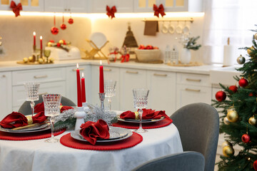 Festive table setting with Christmas decor in kitchen, closeup. Interior design