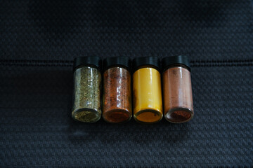 various glass spice jars on the table