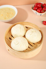 Fototapeta premium Handmade Pork Scallion Steamed Buns in Bamboo Steamer with Dipping Sauce