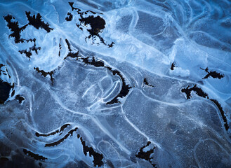 winter background shapes on frozen water surface