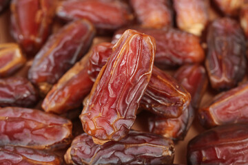 Golden dried dates fruits close-up - healthy natural sweet snack food ingredients